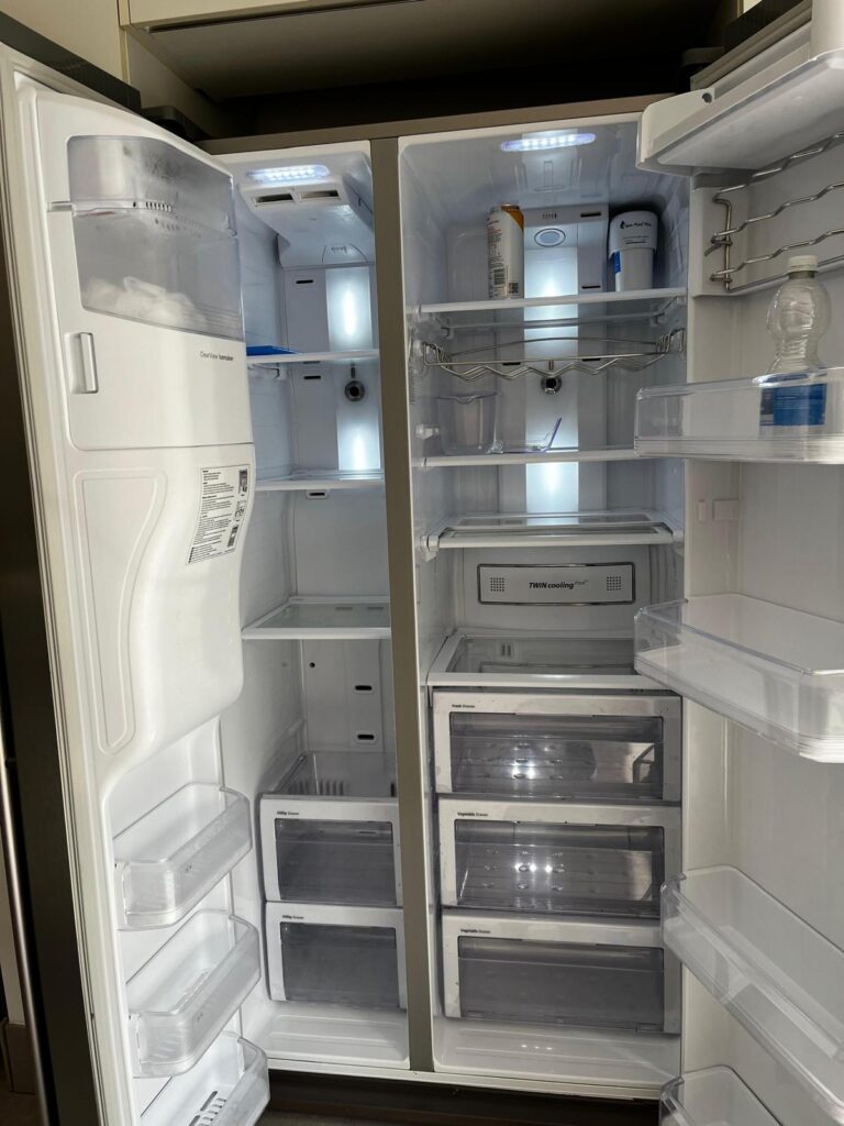 Stainless steel American-style fridge freezer after professional kitchen cleaning, with finish.freezer after a deep clean showing spotless interior